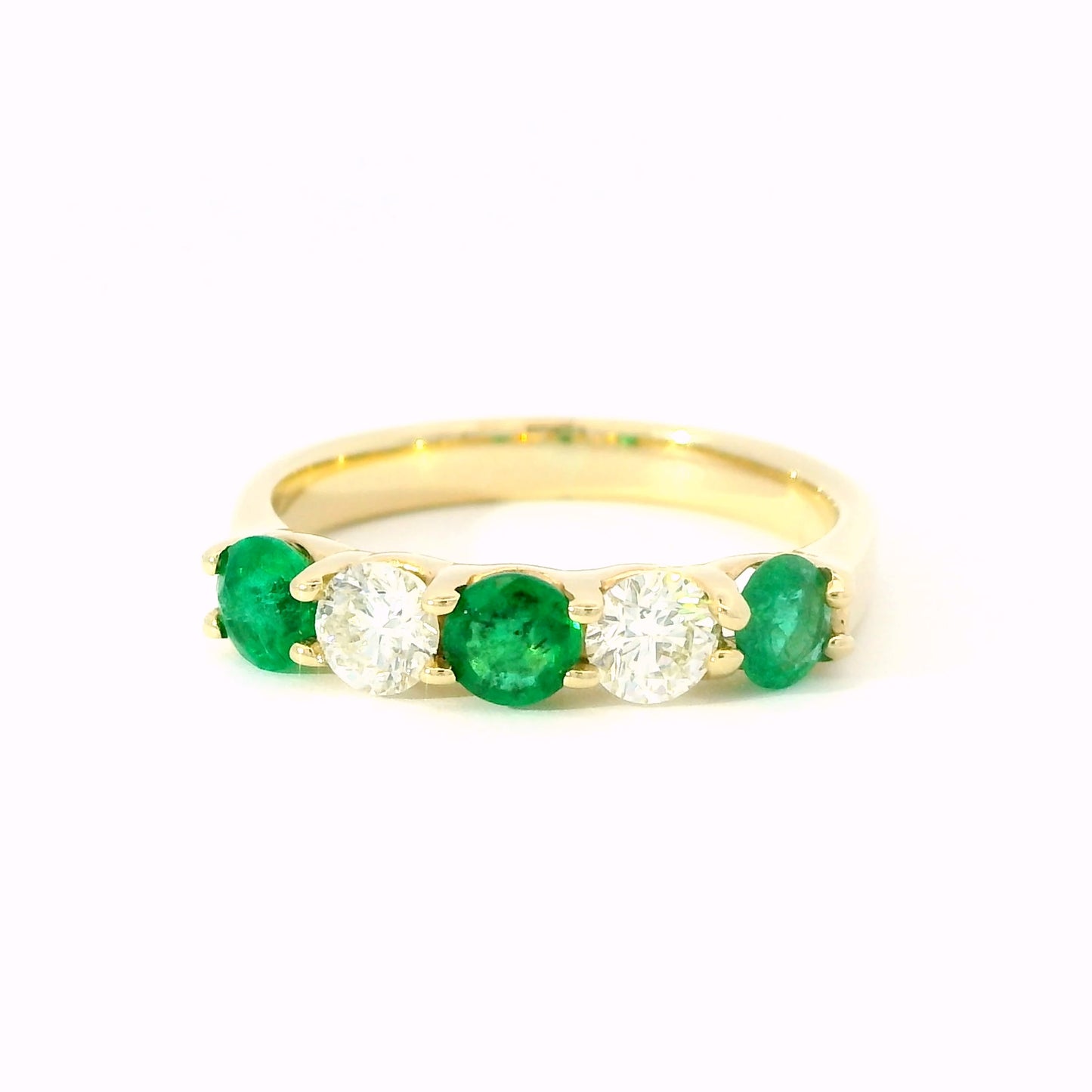 round diamond and emerald ring