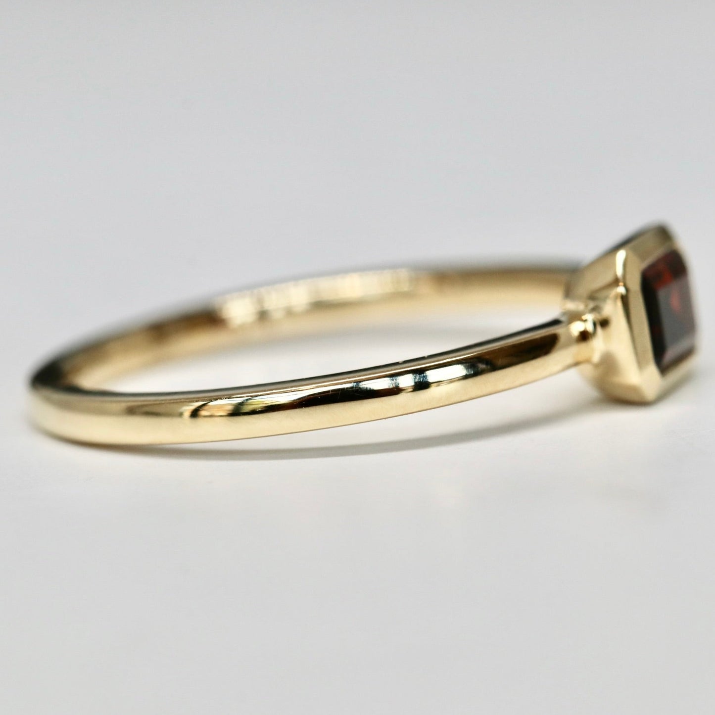 Bezel set Emerald Cut Garnet Ring in 14k Gold