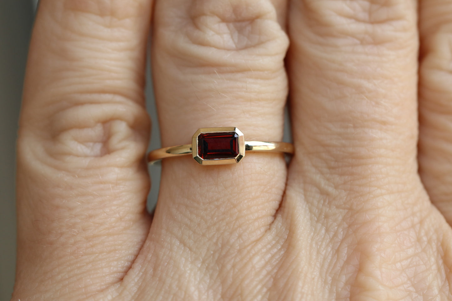 Bezel set Emerald Cut Garnet Ring in 14k Gold