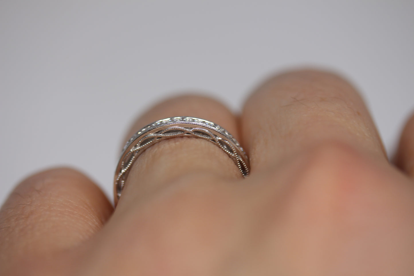 Decorative Channel Set Round Diamond Wedding Band with Twist Design on Sides