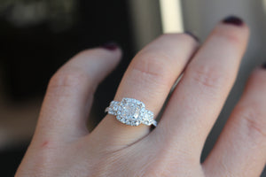 white and rose gold three stone engagement ring for cushion cut diamond center