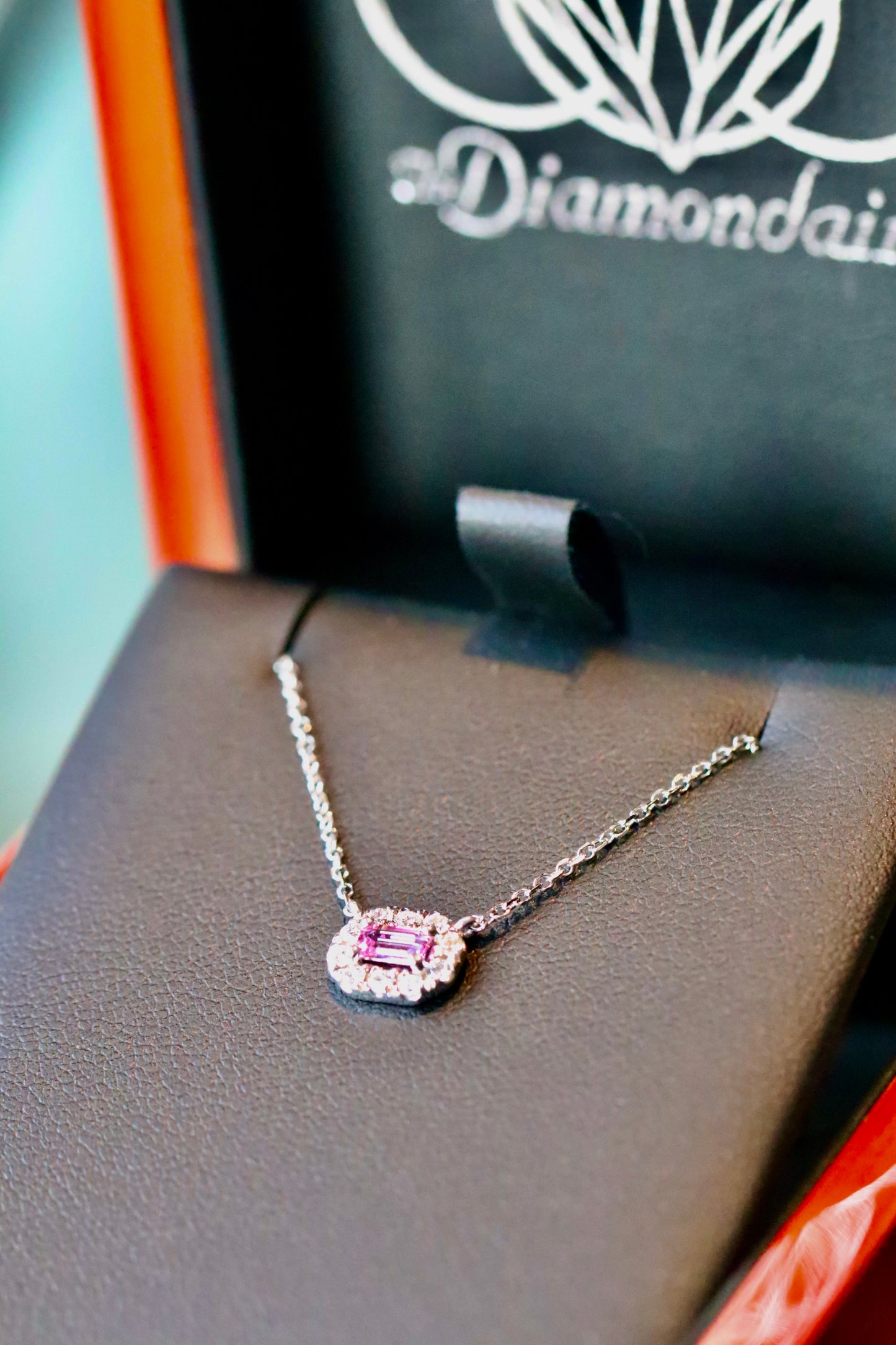 Emerald Cut Pink Tourmaline Surrounded by a Diamond Geometric Halo