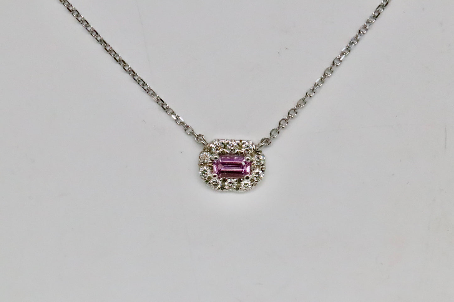 Emerald Cut Pink Tourmaline Surrounded by a Diamond Geometric Halo