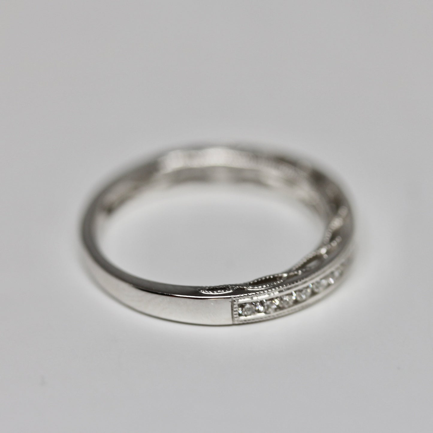 Decorative Channel Set Round Diamond Wedding Band with Twist Design on Sides