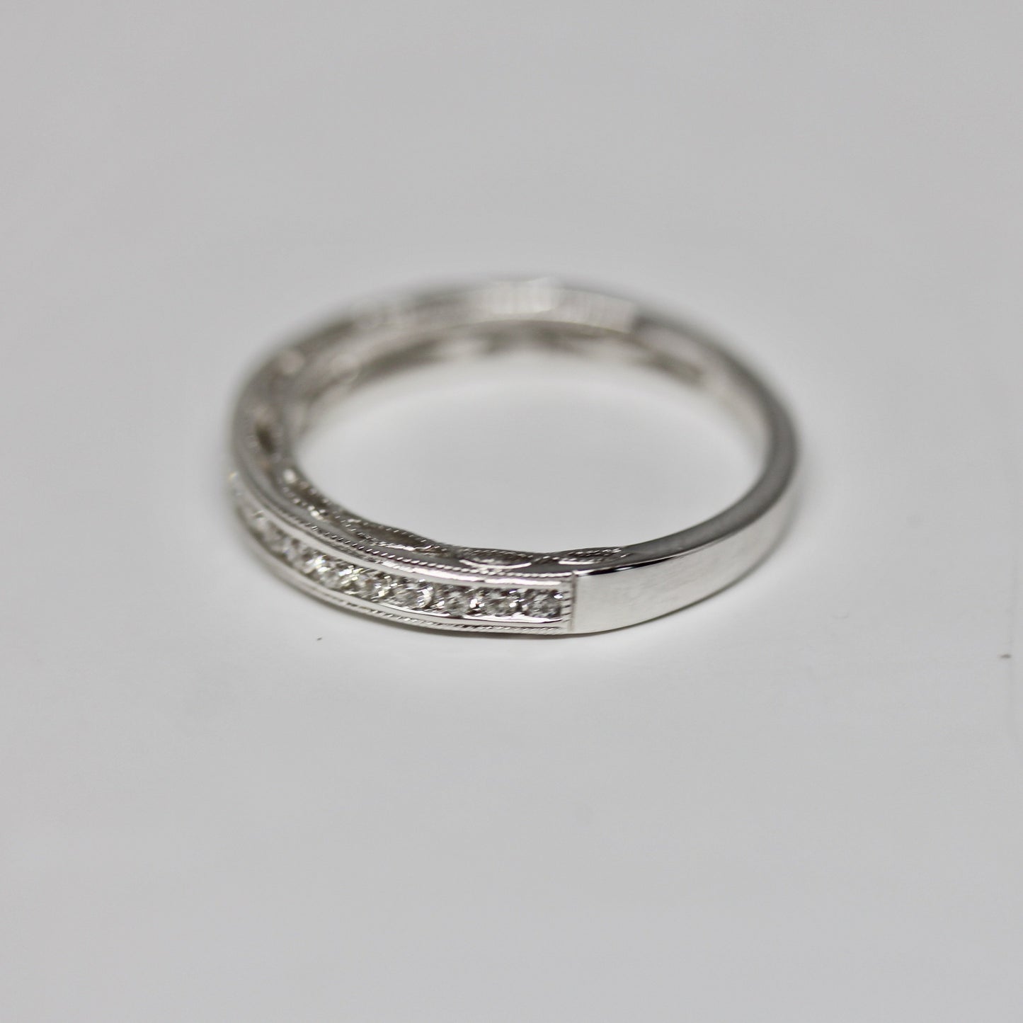 Decorative Channel Set Round Diamond Wedding Band with Twist Design on Sides