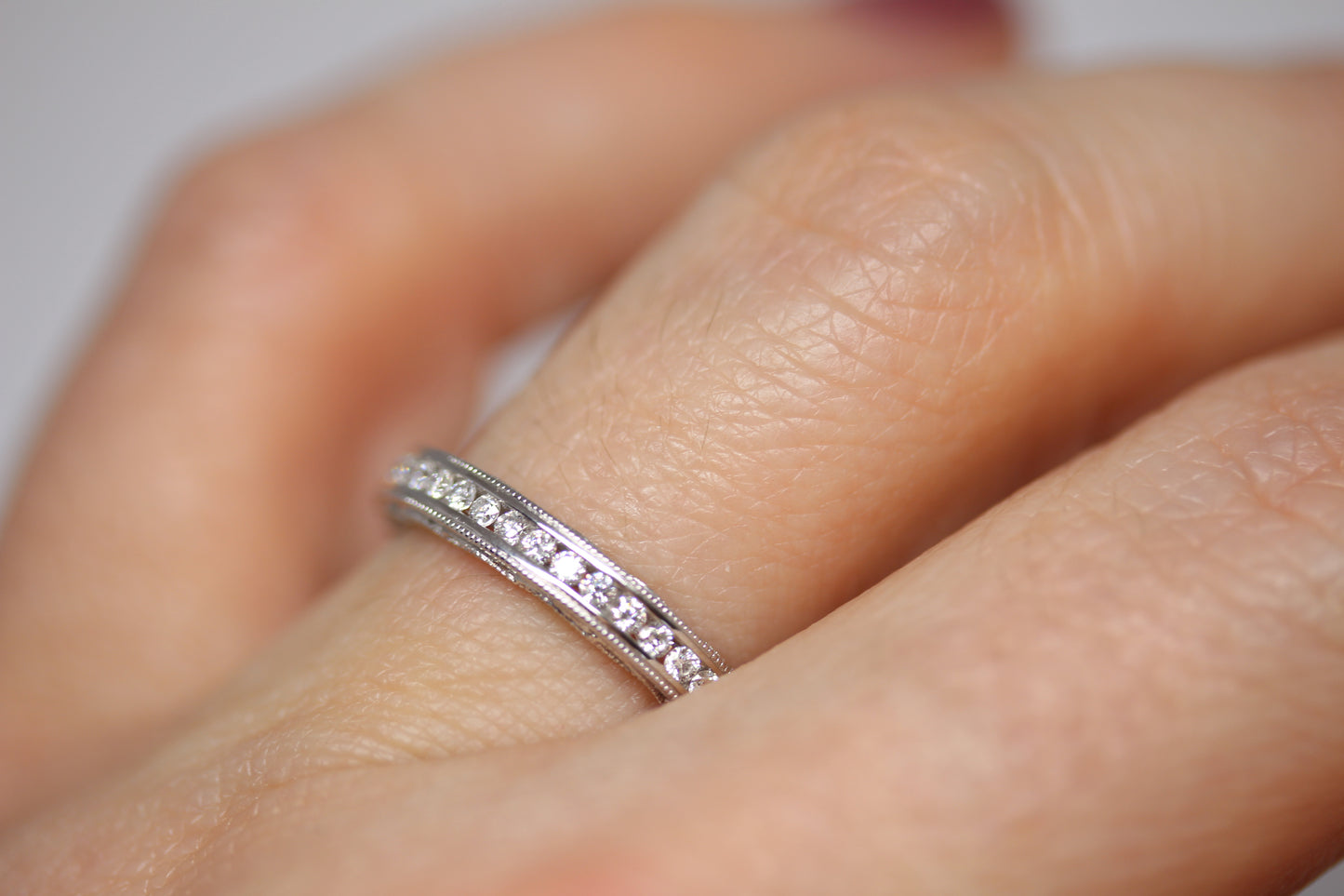 Decorative Channel Set Round Diamond Wedding Band with Twist Design on Sides