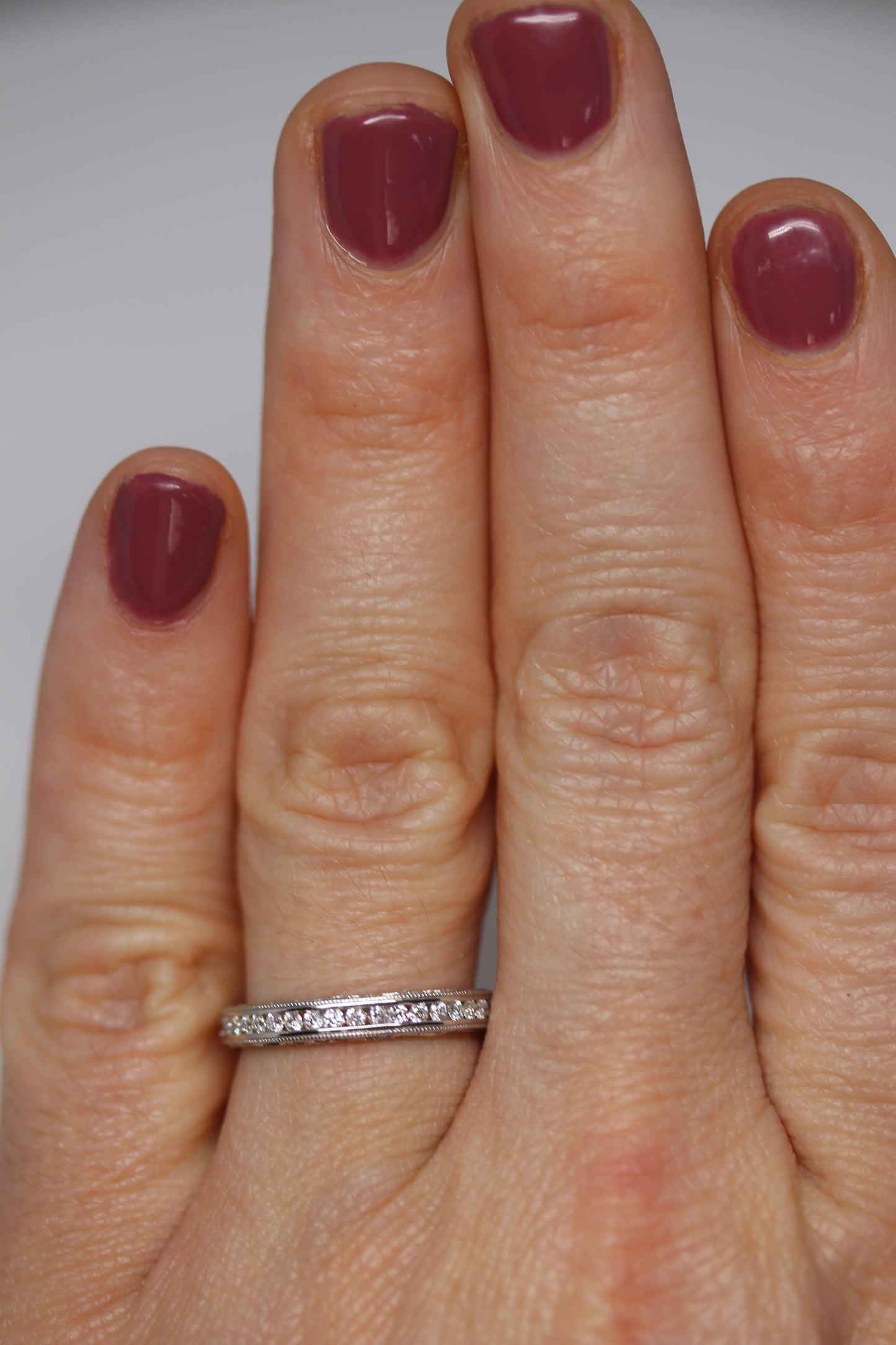 Decorative Channel Set Round Diamond Wedding Band with Twist Design on Sides